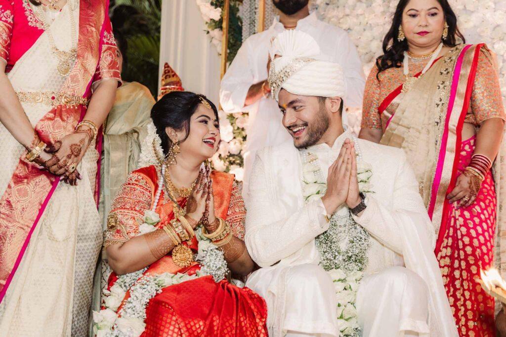 Bride and groom sharing a romantic moment under soft sunset light, captured in cinematic wedding style.