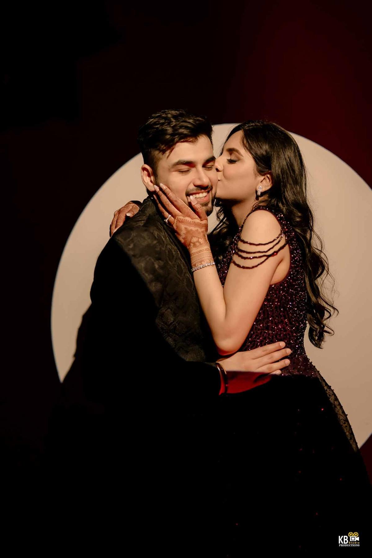 Bride kissing groom on cheek during emotional moment in Gurugram wedding ceremony