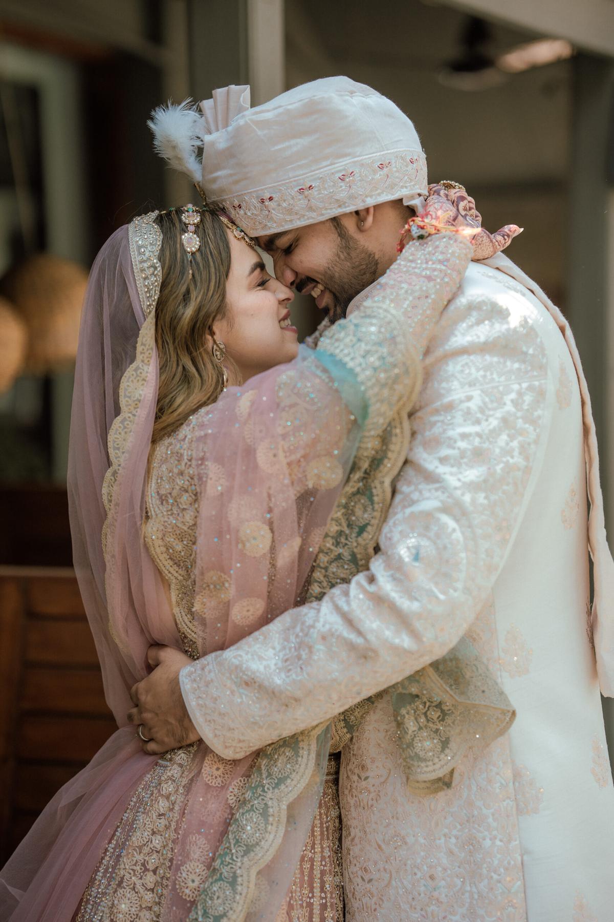 Bride and groom hugging and smiling joyfully, captured by wedding photographers in Gurugram