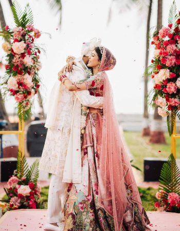 Bride and groom embracing joyfully after exchanging garlands in Gurugram wedding