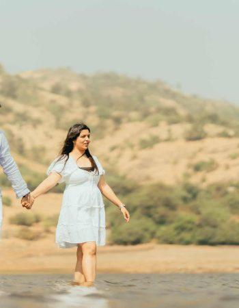 Romantic couple photoshoot at a beautiful lake with mountain backdrop in Mussoorie, Udaipur, and Nainital