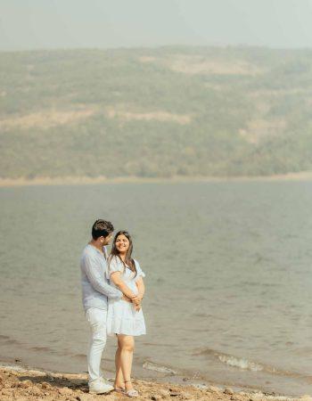 Romantic couple photoshoot in Manali with snow-covered mountains, pine forests, and golden sunset glow