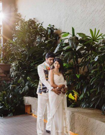 Bali photoshoot at Uluwatu cliffs featuring a couple in wedding attire during a pre-wedding shoot, captured by top wedding photographers in Bali. Bride and groom at Uluwatu sunset wedding