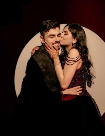 Bride kissing groom on cheek during emotional moment in Gurugram wedding ceremony