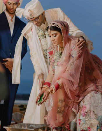 Bride and groom exchanging vows at sunset mandap in Bali, captured by KB Studio Productions – luxury destination wedding photography