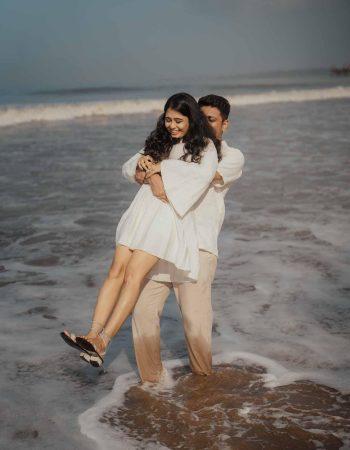 Romantic candid pre-wedding shoot in Dubai with couple posing against Burj Khalifa at sunset